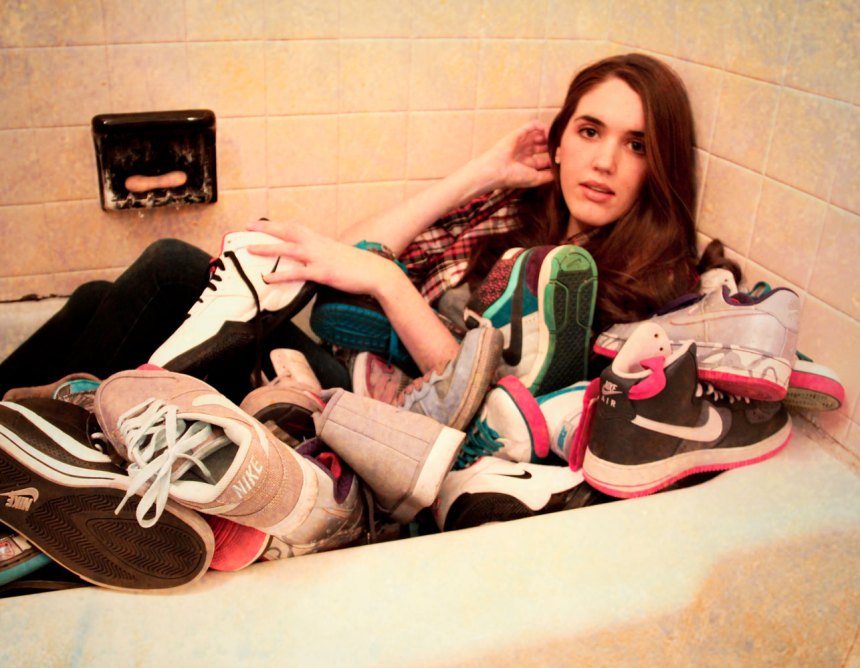 bathing in Nike bathtub full of Nikes
